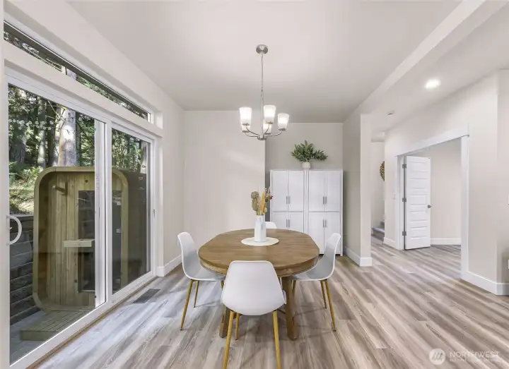 Dining area positioned next to sliding glass door for easy indoor-outdoor access.