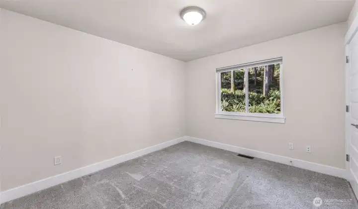 Secondary bedroom with large window and natural light