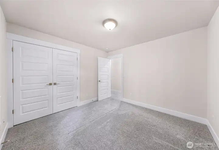 Secondary bedroom with large window and natural light