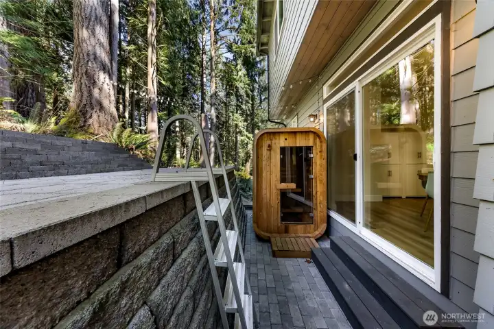 Exterior patio area with sauna and access to lower level