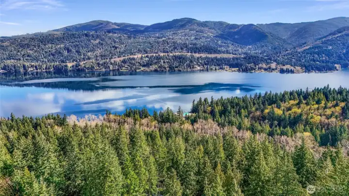 Elevated aerial showing wooded surroundings and lake views