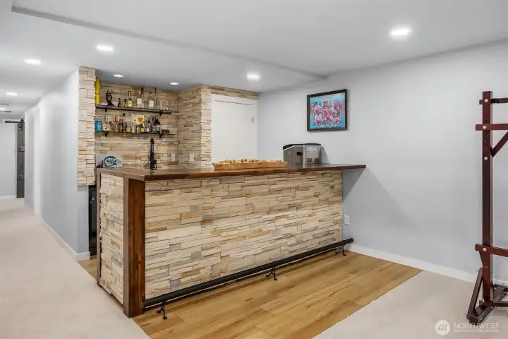 The highlight of the new lower family/great room is this stacked stone wet bar. Love the glazed wood top and trim. Seating space for many 'patrons'.