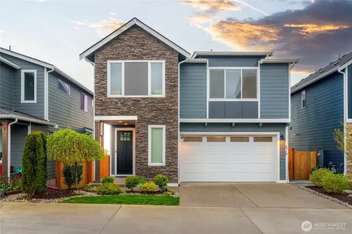 Large windows and textural interest enhance curb appeal. Garage door has Liftmaster "close from anywhere" mechanism.