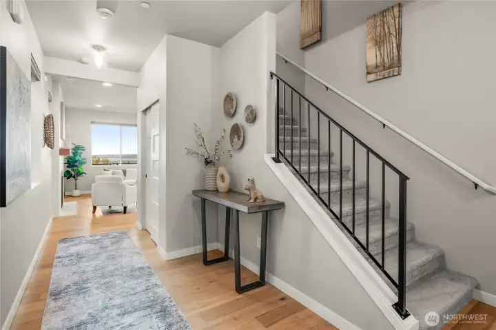 Front door leads to entry with coast closet, staircase, and powder room.