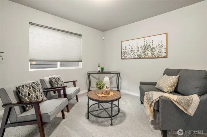 At the top of the stairs is a large, open bonus area opening onto the laundry room.