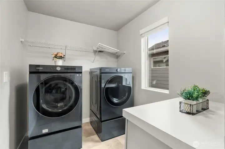 As well as Samsung washer and dryer, the laundry room has a counter top for easy folding.