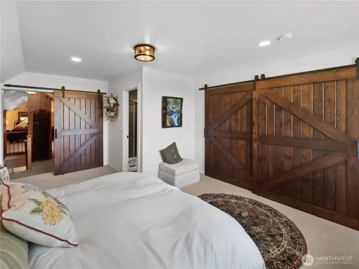 Custom barn door made from cedar grown and milled on the property leads to a spacious walk-in closet Custom barn door made from cedar grown and milled on the property leads to a spacious walk-in closet