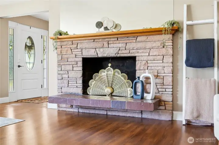 A classic wood-burning fireplace creates a cozy focal point for relaxing evenings.