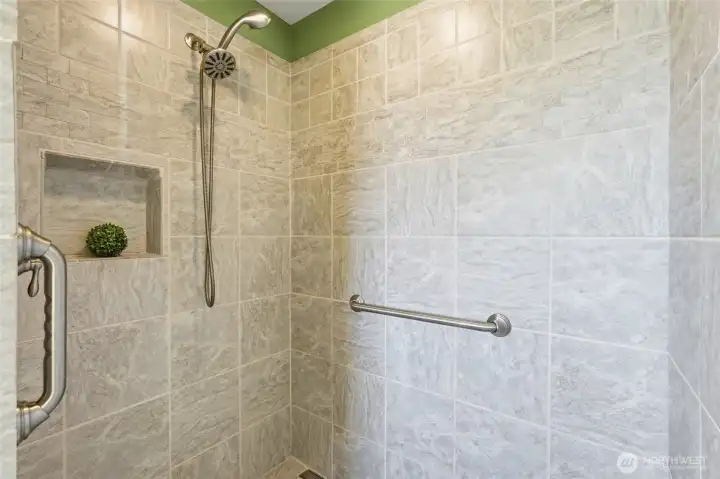 Grab bars have been thoughtfully installed for additional support and safety. The design is ideal for aging in place or accommodating a range of mobility needs.