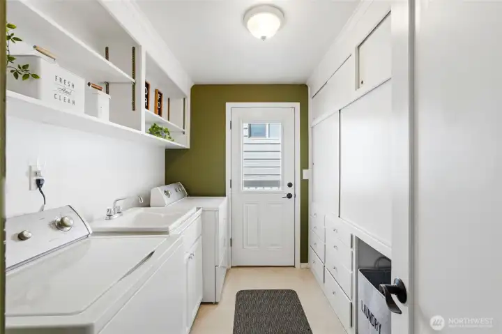 The oversized laundry and utility room provides exceptional storage rarely found in similar homes. Built-in cabinetry and pantry space help keep household essentials organized.