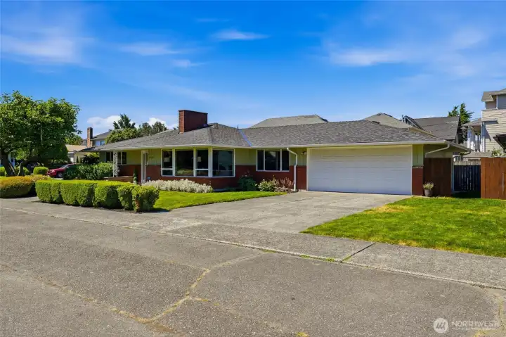 The attached garage offers convenient covered parking and additional storage options. Off-street parking provides extra room for guests or multiple vehicles.