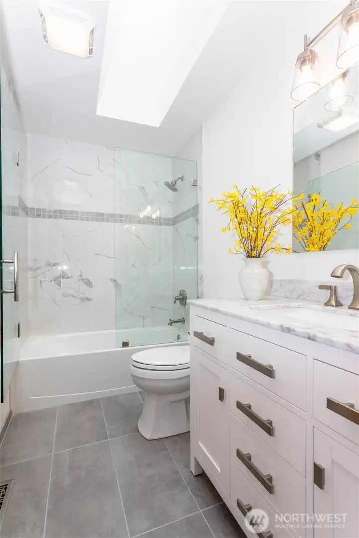 Beautifully updated main bathroom with skylight