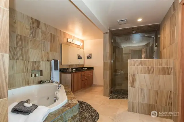 Travertine flooring, Teak Sandstone wainscoting, The shower is Teak Sandstone, and the cabinets Cherry Maple with Uba tuba Granite countertops, the fixtures are breathtaking and elegant . The doors are VG Fir Doors hand carved and solid. Romance and relax, treat yourself to the elegance and relaxation with a view of the Sound right from your Bath in your master Suite