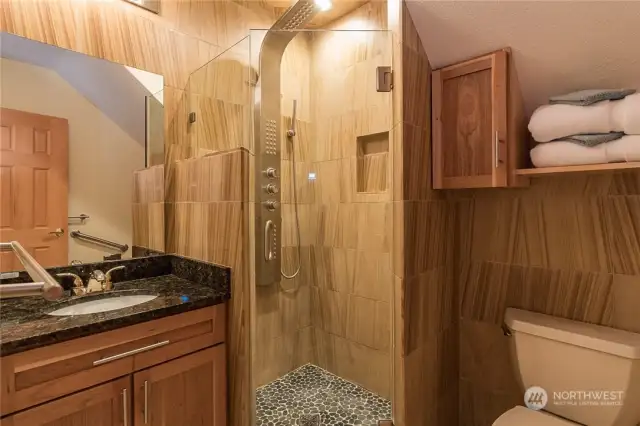 Travertine flooring, teak Sandstone Wainscoting,Teak Sandstone Shower, Cabinets are Cherry Wood/ Maple and the counters are Uba Tuba Granite. Just amazing, just look at the Shower fixtures? Pride of ownership is everywhere.
