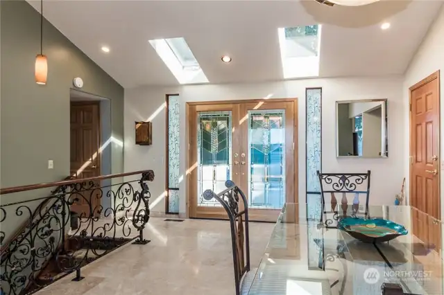 Looking back at the entrance filled with sunshine and the joy of all the beauty surrounding you as you enjoy being at home. Skylights are a great touch!