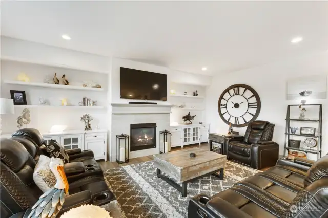 The media consoles and floating shelves in great room add beautiful detailing and stay with the home.