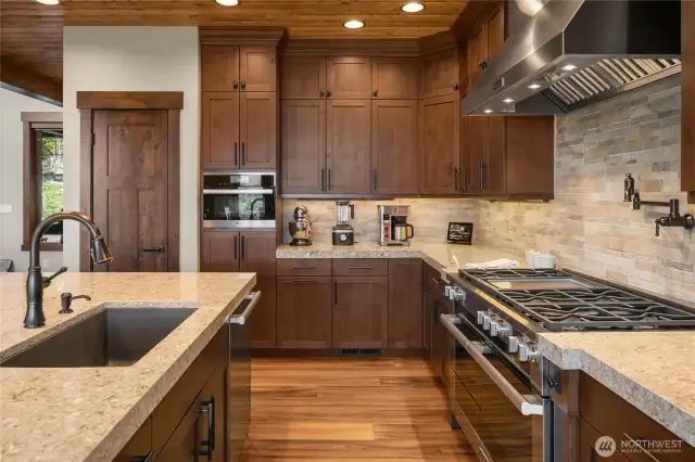 Gorgeous all wood custom cabinets with pull out drawers feature soft close. Touch faucet, steam oven, spacious pantry and pot filler make this a dream kitchen.
