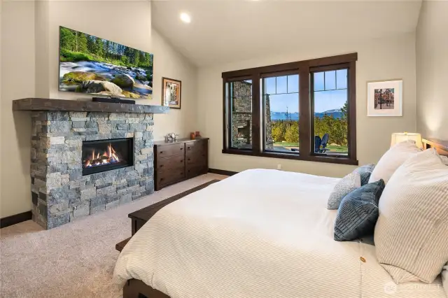 Primary bedroom with fireplace and lovely views.