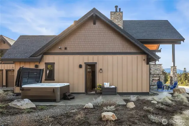 Exit the primary bedroom to the hot tub patio.