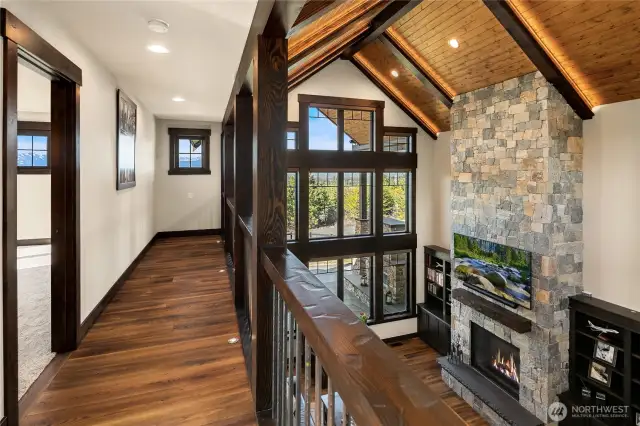 Hallway with built in floor lighting leading to third bedroom. Views of the Stuart Mountains from every window.