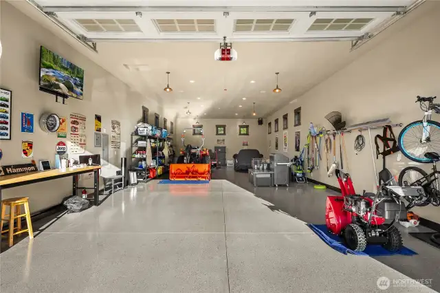 This fully finished out detached garage has spotless epoxy floors, beautiful windows, a private entrance, heat, entertainment system and built in workbench and racks.