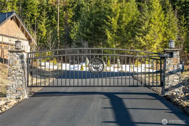 Private gate with keypad entrance and remote control. Driveway and road leading to property is all paved and parking pad in front of garage is heated with automatic sensors to melt snow.
