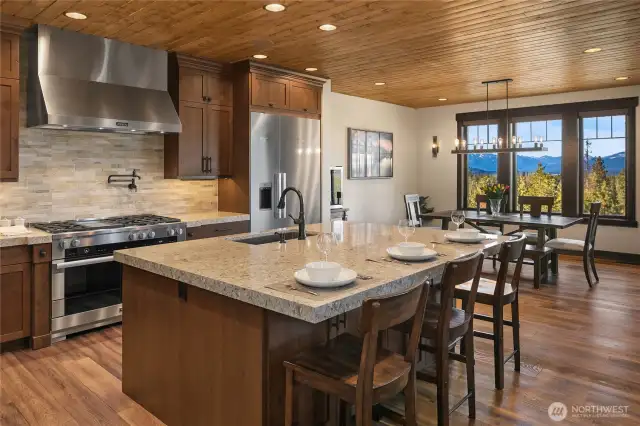 Chef's kitchen with breakfast bar and quartz countertops.
