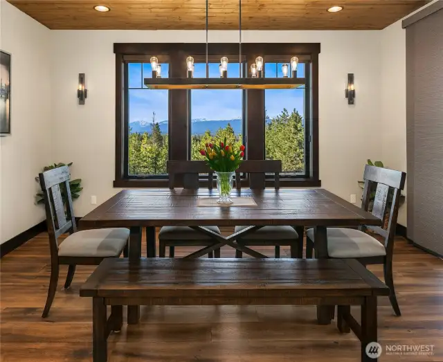 Spacious dining room with view of the mountains and custom lighting.