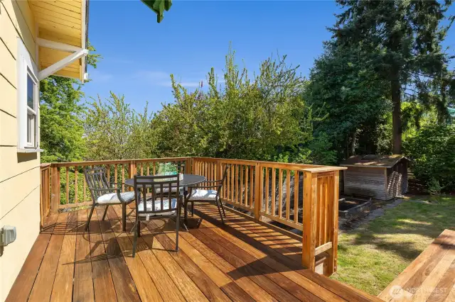 the kitchen opens to the tigerwood deck and fenced-in backyard