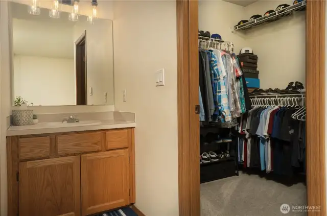 vanity and walk in closet of the primary