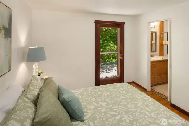 Primary bedroom with access door to deck.