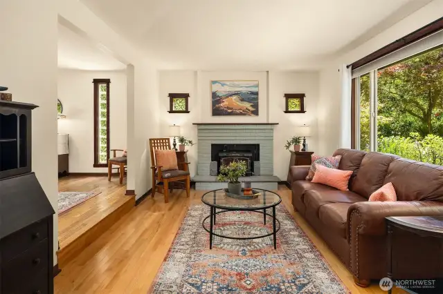 Living room with hardwood floors and fireplace.