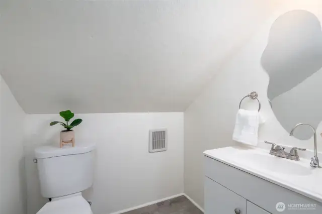 This newer half bath attached to primary bedroom.