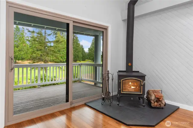 A newer sliding door off the living room opens to a west-facing covered deck with serene golf course and wooded views. The environmentally friendly fireplace heats the whole condo and a large wood-pile comes with it.