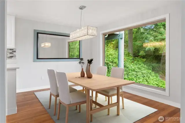 This beautifully updated condo features a 5-year-old, triple-paned enlarged window that offers a stunning, elevated view of the landscape. A mirrored accent wall, which conveys with the home, reflects the scenery for an added sense of openness, while a modern chandelier brings casual elegance and warmth.    This beautifully updated condo features a 5-year-old, triple-paned enlarged window that offers a stunning, elevated view of the landscape. A mirrored accent wall, which conveys with the home, reflects the scenery for an added sense of openness, while a modern chandelier brings casual elegance and warmth.