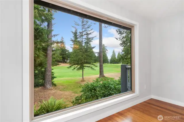 The sellers remodeled this wall by installing a huge, triple-paned window to bring in the views of the golf course and woods. Private and lovely, this elevated room is filled with natural light and beauty.