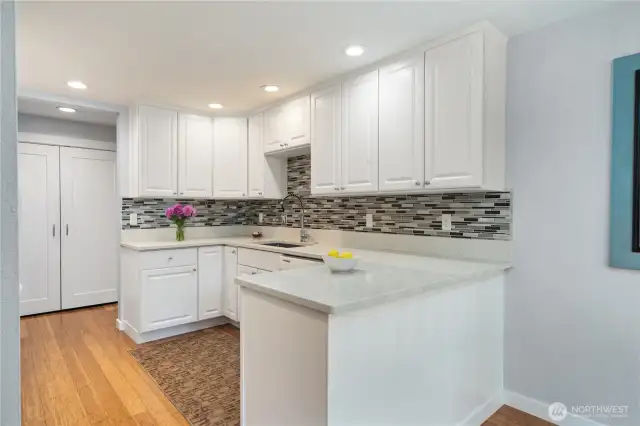 The kitchen was remodeled with quartz counters, a glass tile backsplash, quality cabinets and appliances, a new sink and hardware, updated ceiling lights, and more. Beautiful and inviting, it’s a space that enhances both the kitchen and the home.