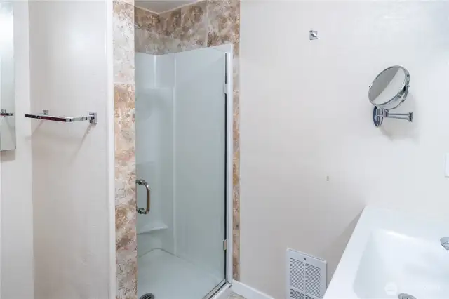 Walk-in shower in the primary bedroom's private bath.