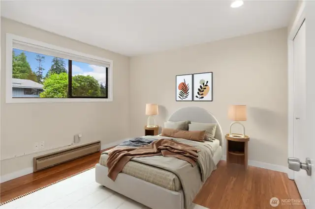 The first of two guest bedrooms, this lovely room has hardwood floors, a spacious closet, and window coverings.