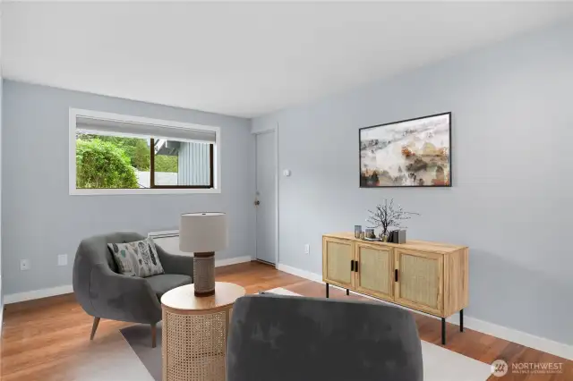 The second guest bedroom is staged as a den, and was used as a den by the sellers. In the background you'll see a door that leads to the one-car garage - brilliant!  Easy to unload the groceries from the car to the kitchen, especially in the winter time.
