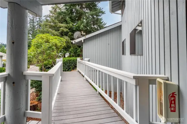 Another view of the breezeway, which will undergo repairs in Sept. 2025 to insure lasting use and safety. The siding is wood, the roof is composite, and many of the windows in the condo have been replaced and upgraded.