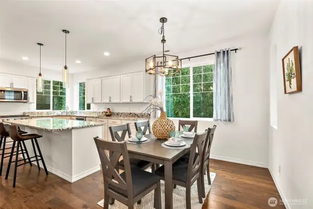Eat in kitchen area, gorgeous granite counters with large center island and breakfast bar. Notice the exquisite lighting.