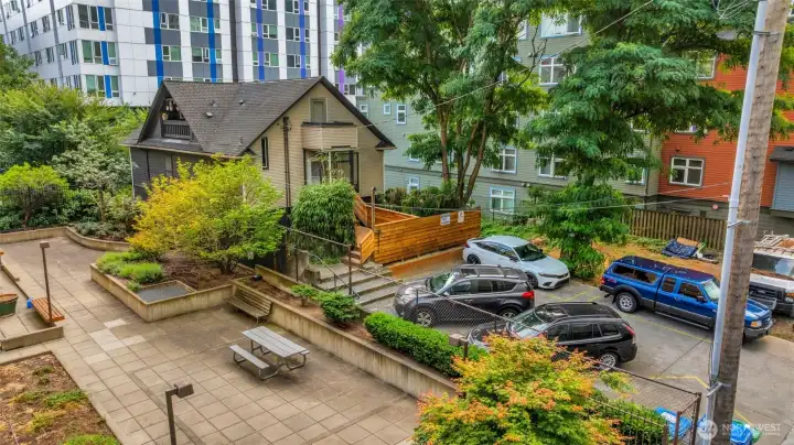 Five surface parking spaces fully rented for up to $190 each a month. Patio in picture is part of neighboring property.