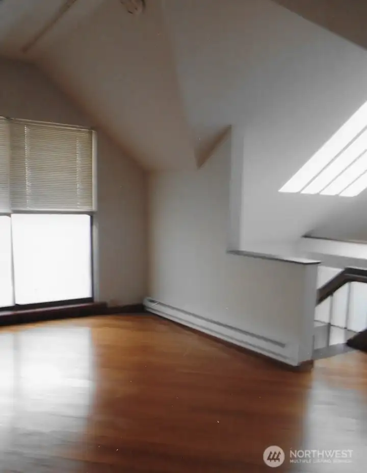 Unit 3 Upstairs bedroom and separate loft on other side of stairs-note the skylights and balcony off bedroom