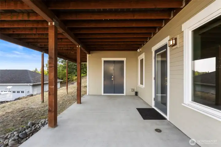 Covered patio off the guest bedroom provides a private outdoor retreat with easy access to the yard.