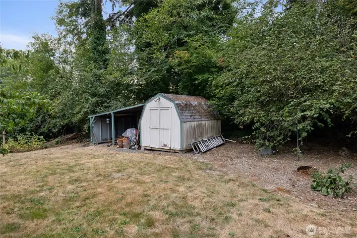 Back yard storage shed, plus covered storage.