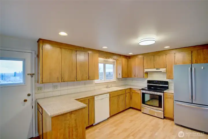 Abundance of cabinetry in this large kitchen. Door leads to massive back deck.