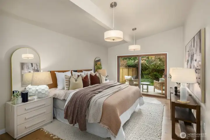 Private primary suite with walk-in closet and sliding glass doors to a tranquil deck.