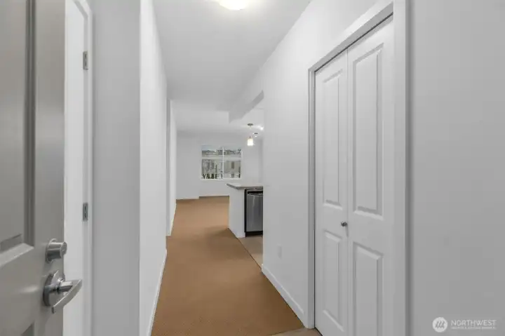 Front entrance with laundry room to the left and coat closet to the right.