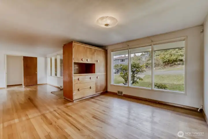 Dining Room and Living Room with that super cool cabinet. The overhead light fixture is original, with a scene of swans etched into the cover. So many lovely original details in this home make it easy to restore to its Mid-Century glory. The original blueprints are still there and will stay with the house.